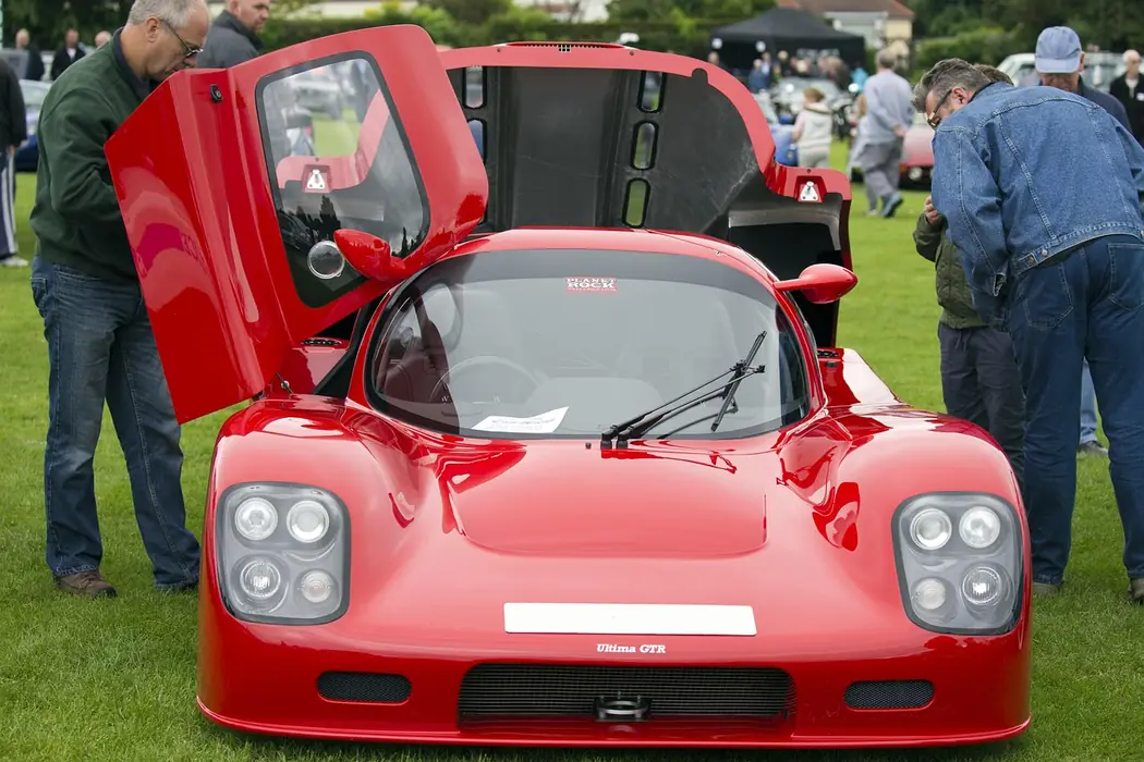 Car enthusiasts showing off hand-built cars at a car show