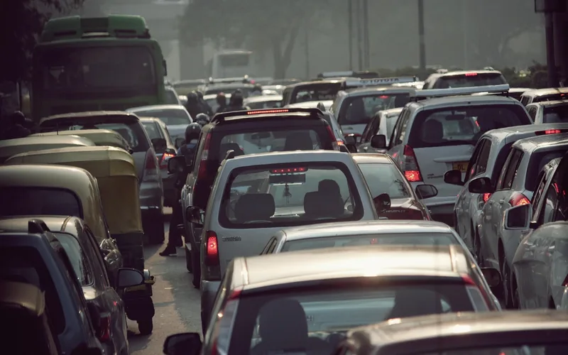 Dense city traffic jam with cars bumper to bumper in haze