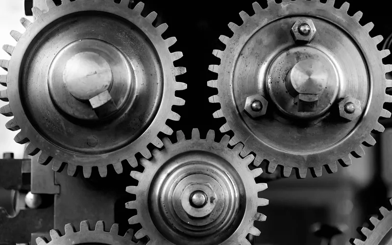 Several metal gears meshing together on a machine