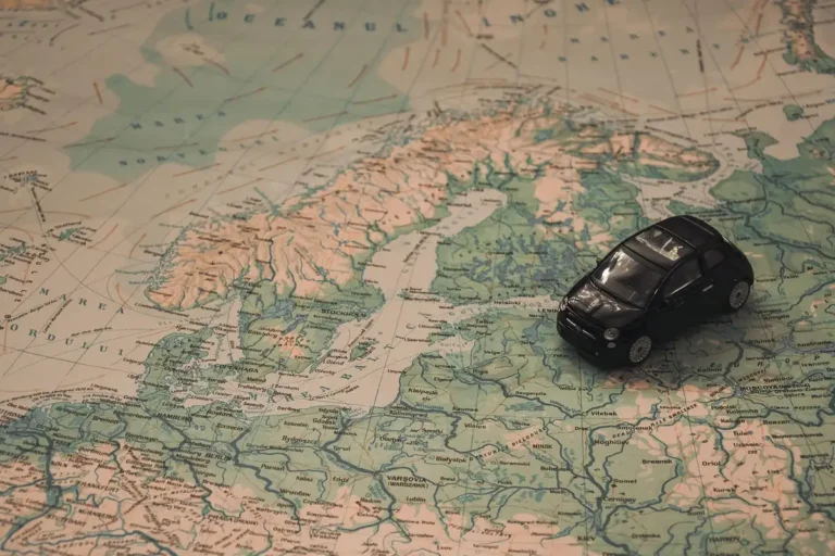 Small toy car placed on a paper map of northern Europe