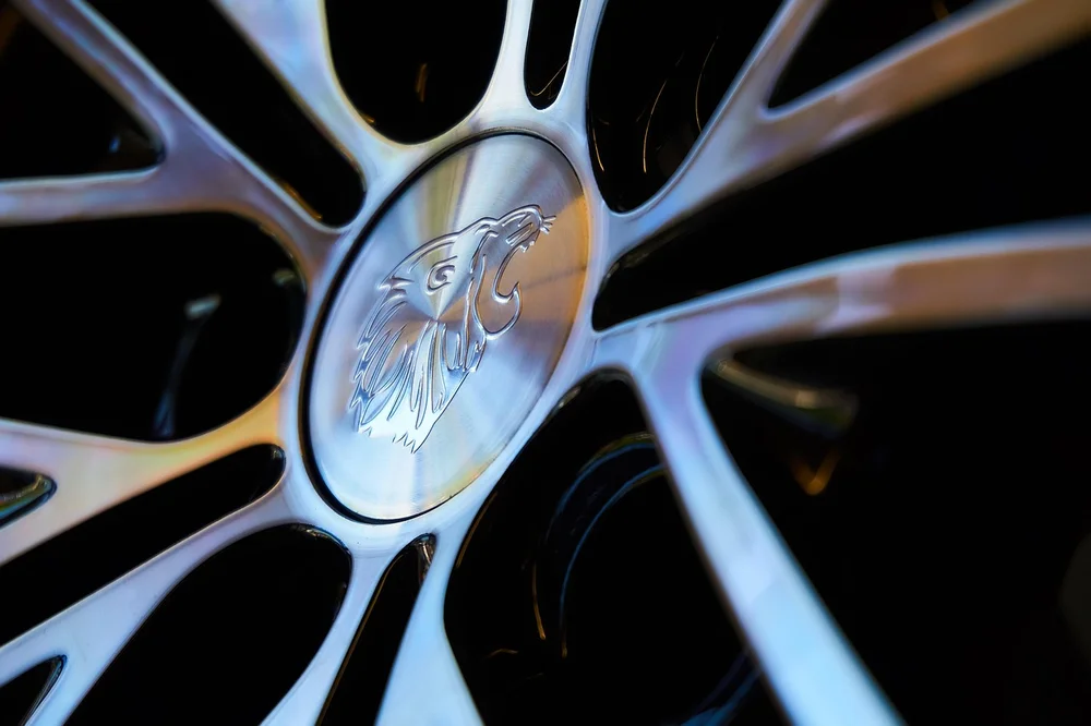 Macro shot of an aftermarket alloy wheel spoke and center cap