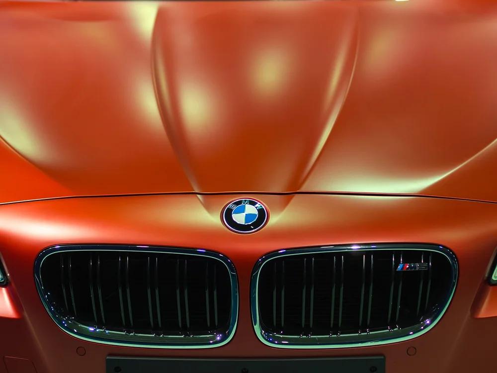 Close-up of the BMW roundel badge on a car hood