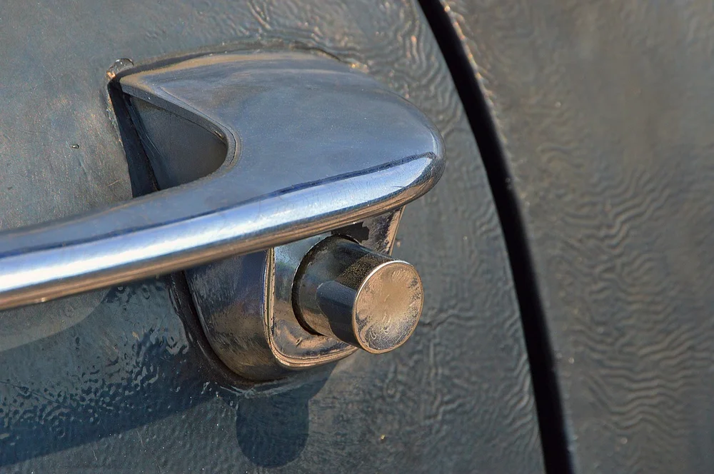 Close-up of a chrome car door handle and latch mechanism