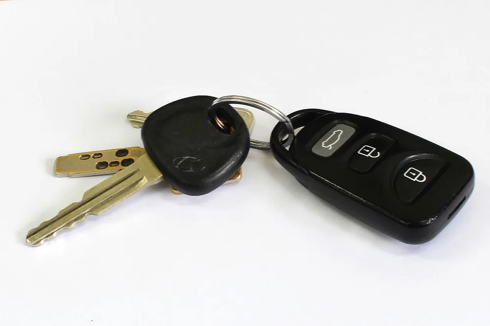 A car remote fob paired with its matching physical blade key