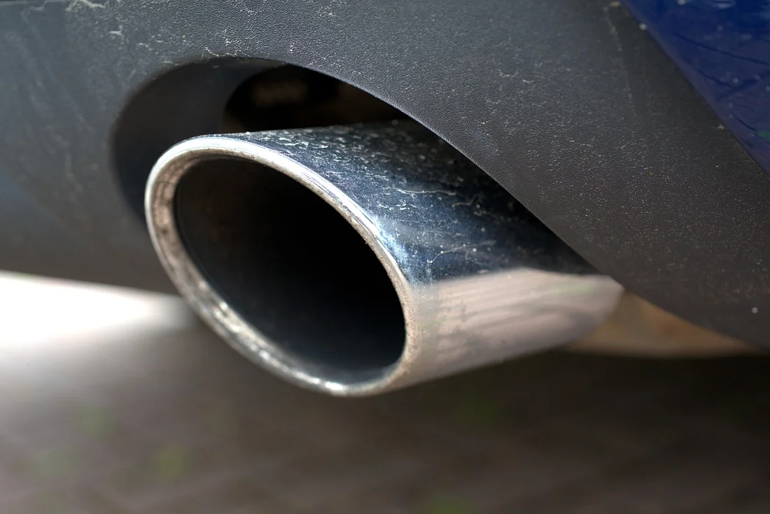 Chrome exhaust pipe outlet, similar to where a Ford Edge's exhaust system exits after the catalytic converters