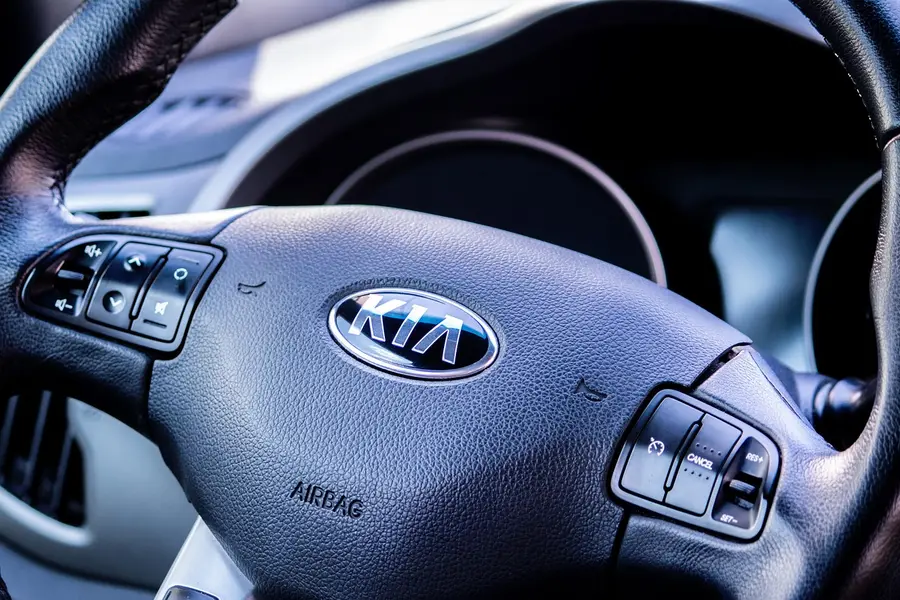 Close-up of the Kia badge on a steering wheel airbag