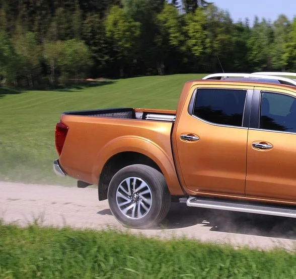 Close view of an open pickup truck bed and tailgate, illustrating where a tonneau cover mounts