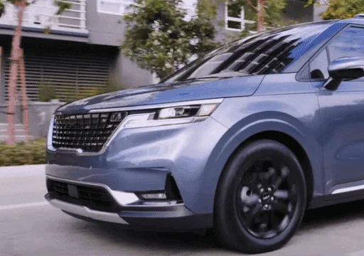 Close-up of the Kia Carnival's front grille and headlight design