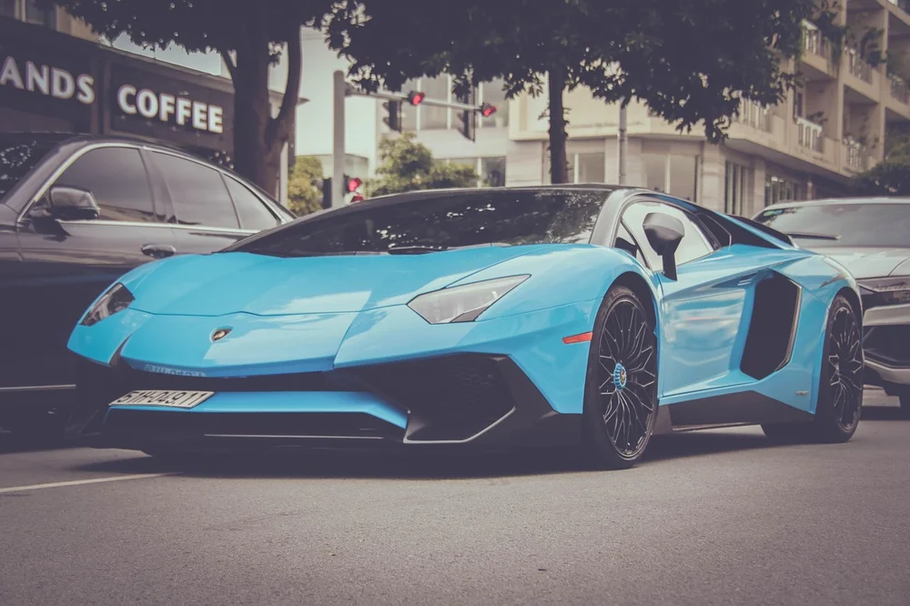 Blue Lamborghini Aventador supercar parked on a city street
