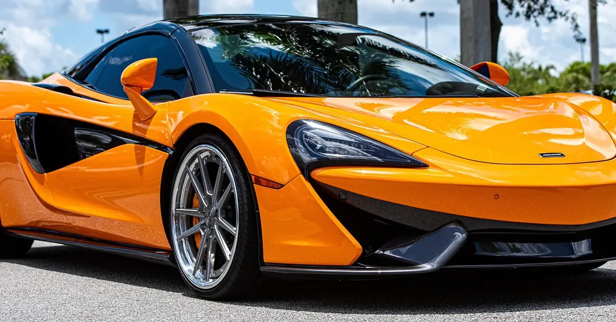 Orange McLaren supercar parked, showing its low, aerodynamic body