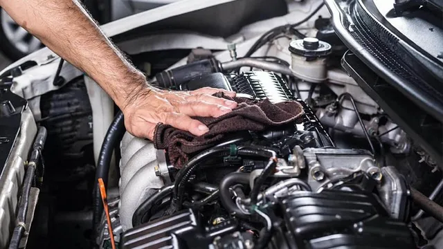 Technician performing an engine bay repair covered under a Toyota Vehicle Service Agreement