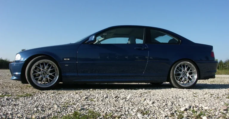 Blue BMW 3 Series coupe side profile