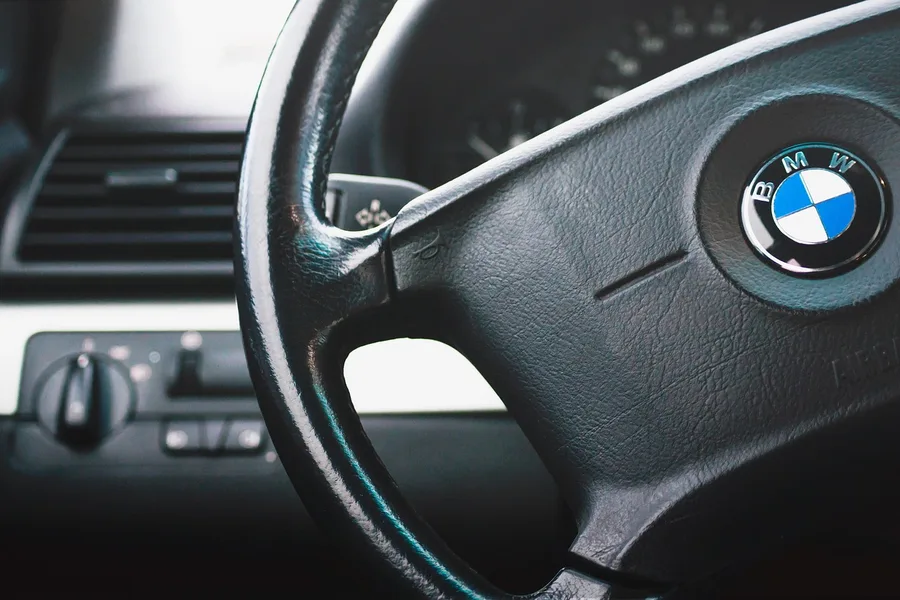 Close-up of a BMW steering wheel and leather-wrapped interior trim