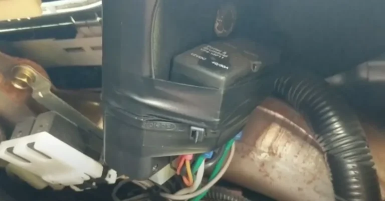 Alarm relay module and wiring harness under a car dashboard
