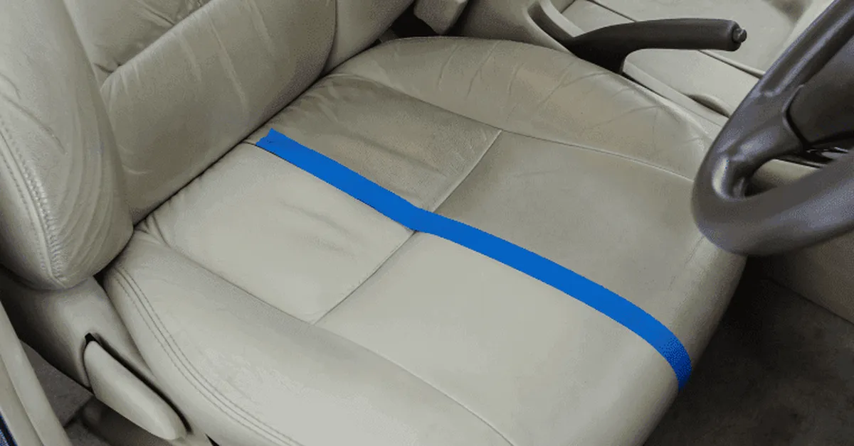 Beige leather car seat mid-cleaning with a visible clean line