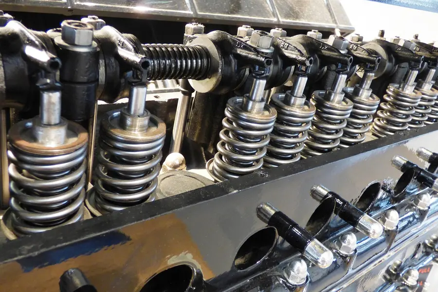 Close-up of a V8 engine cylinder head and valve cover on a Chevy small-block style engine