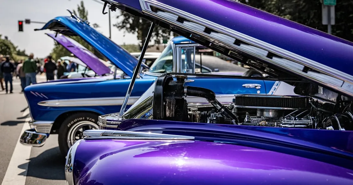 Classic Chevy cars with hoods open showing engine and radiator