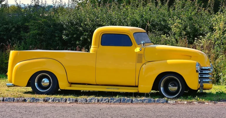 Classic yellow Chevy pickup truck parked roadside