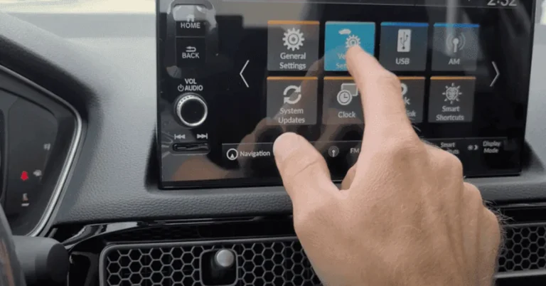 Hand touching the settings menu on a 2022 Honda Civic infotainment screen