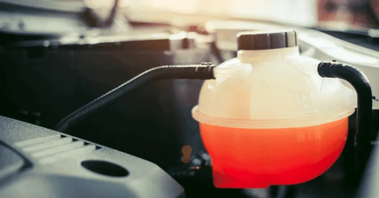 Red coolant visible in a translucent reservoir with MIN and MAX markings