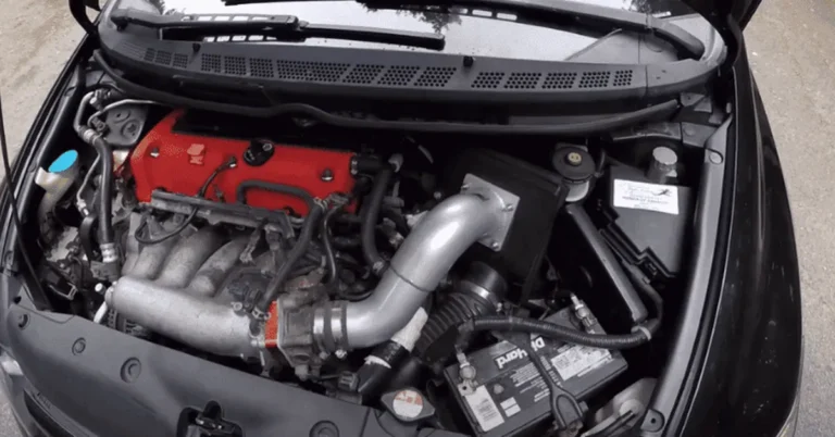 Honda Civic engine bay showing an aftermarket intake and red valve cover