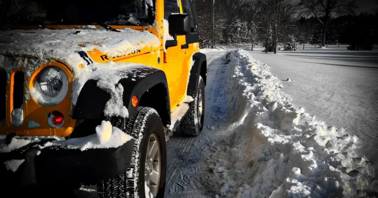 Jeep Wrangler Rubicon front grille and wheel in snow