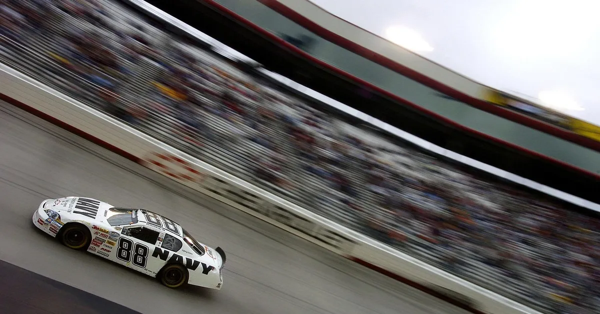 NASCAR stock car racing at high speed on an oval track