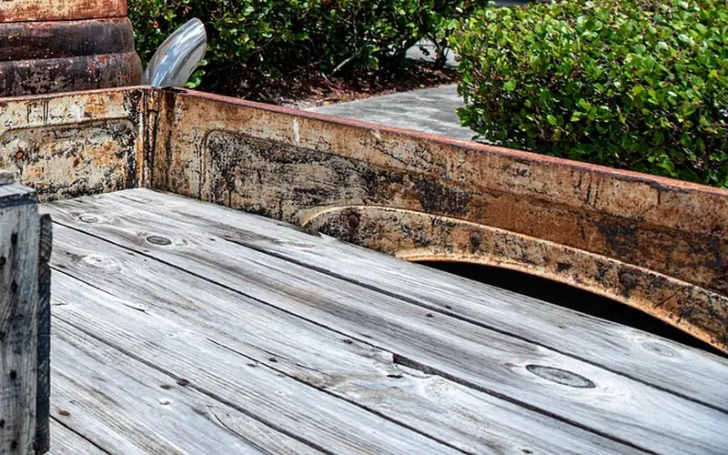 Pickup truck bed with a wooden floor and the wheel arch rising into the bed side