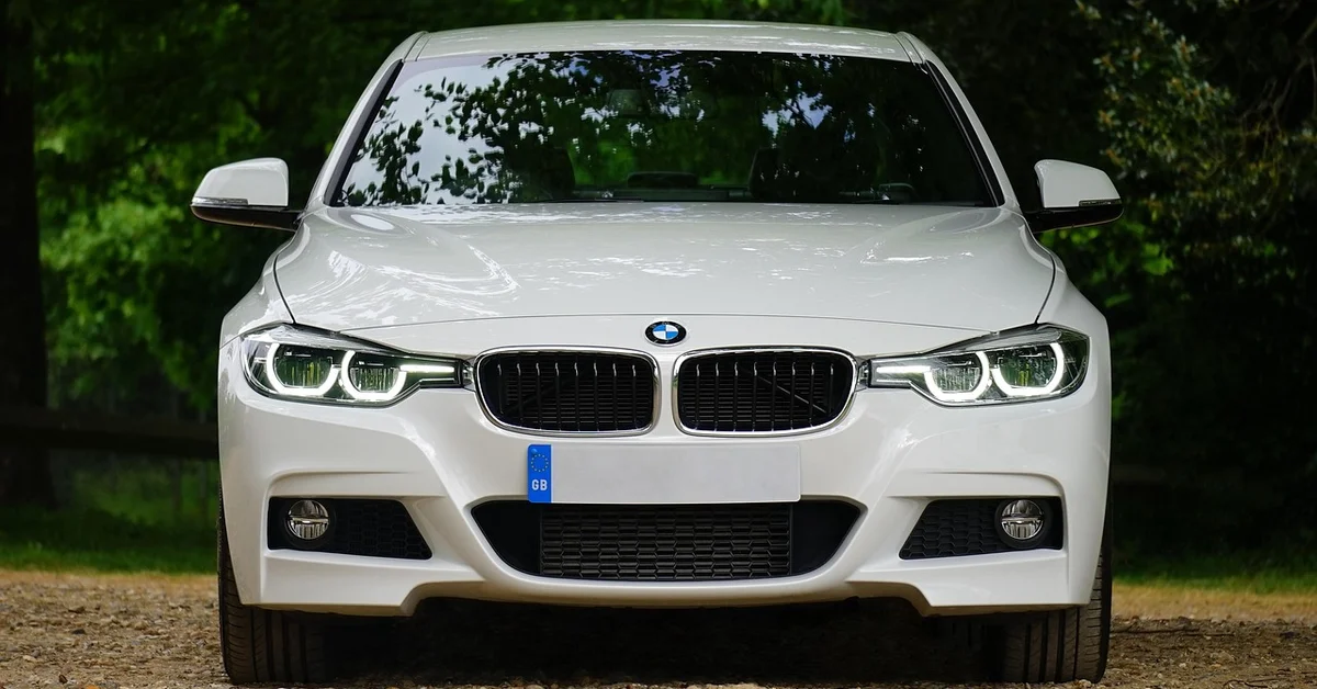 White BMW sedan with a visible front license plate