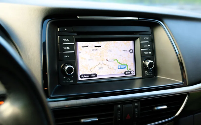 Car infotainment touchscreen showing a navigation map with a route