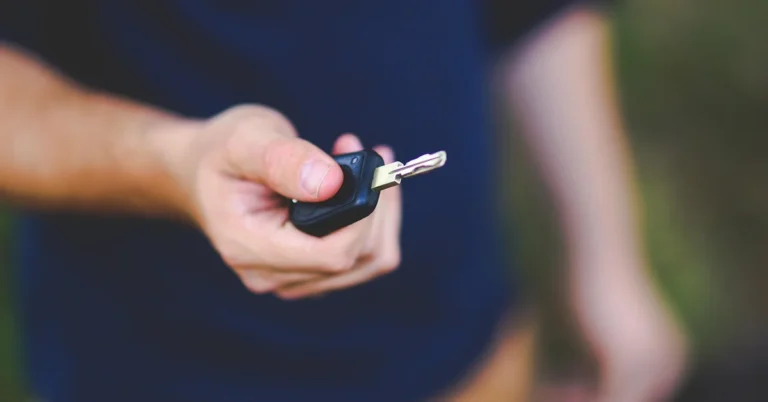 Hand holding a car key fob remote
