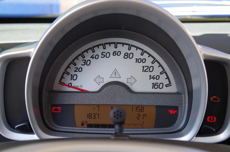 Car instrument cluster with several dashboard warning symbols lit
