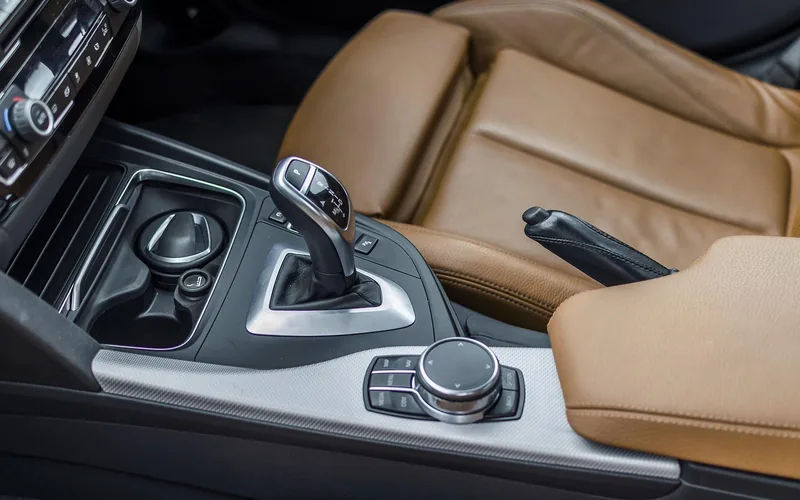 Automatic gear selector resting in the Drive position inside a car cabin Automatic gear selector resting in the Drive position inside a car cabin