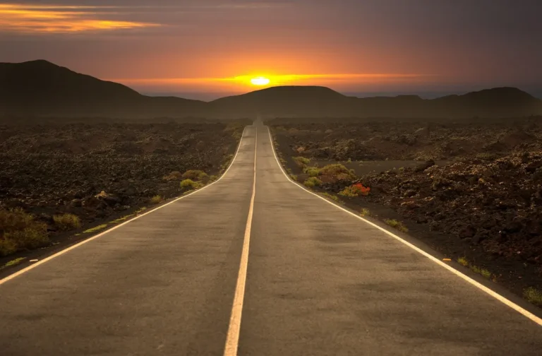 Open road at sunset stretching toward the horizon