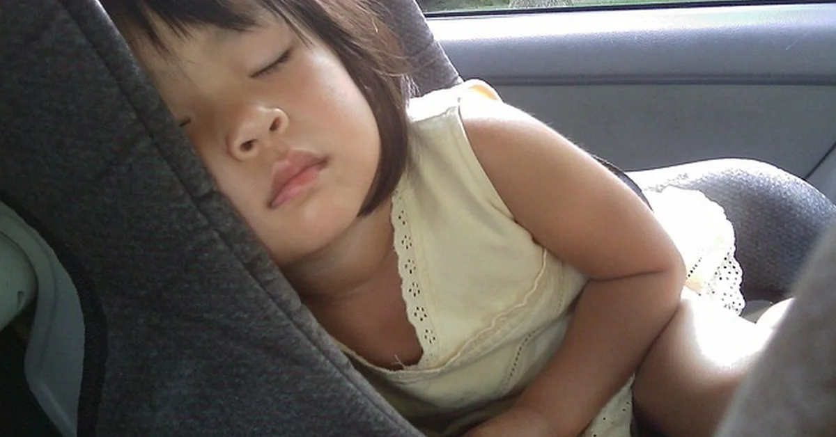 A child sleeping in a properly installed car seat, relevant to bringing your own car seat for an Uber ride