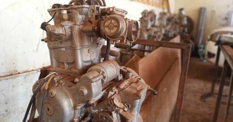 Mechanic servicing a car engine, illustrating that Ford warranty service can be done at any authorized dealer
