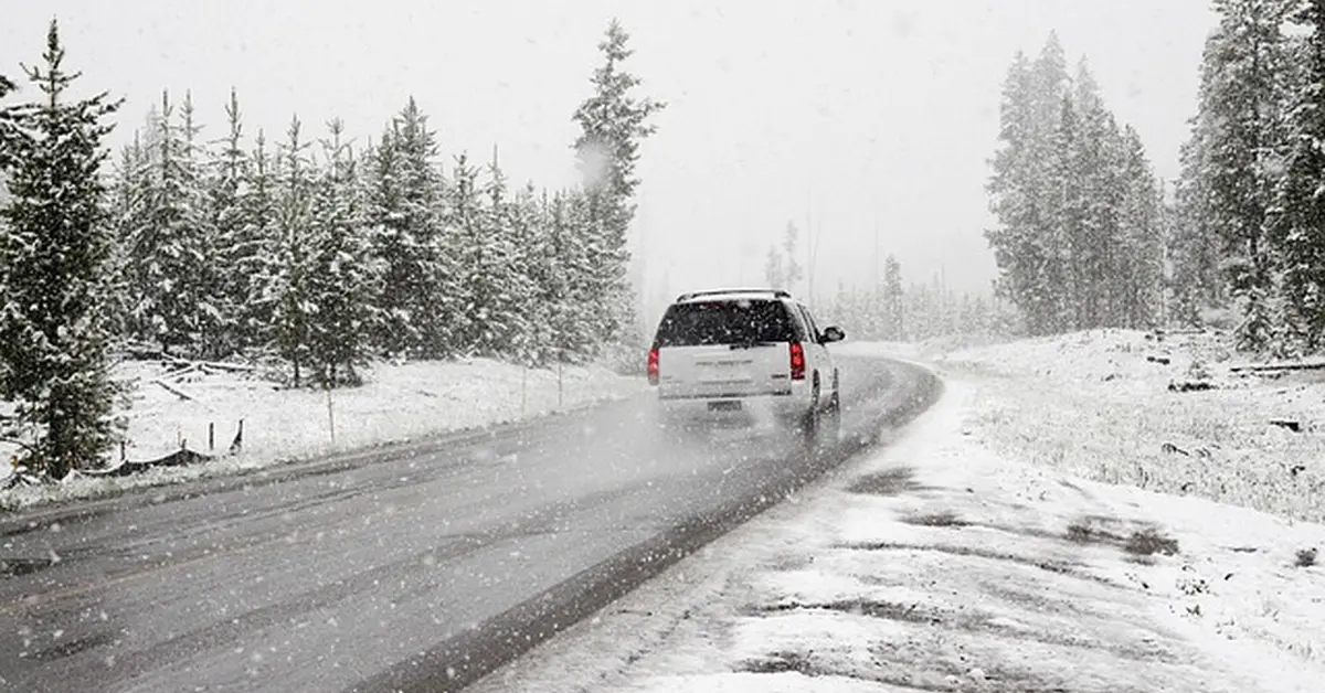 SUV driving on a snowy road, illustrating a crossover vehicle relevant to Ford Escape fuel compatibility