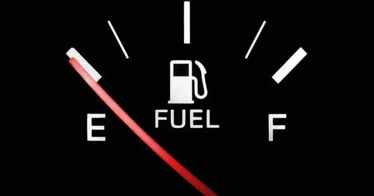 Car fuel gauge needle pointing toward empty, illustrating how far a Ford Fusion can travel on empty