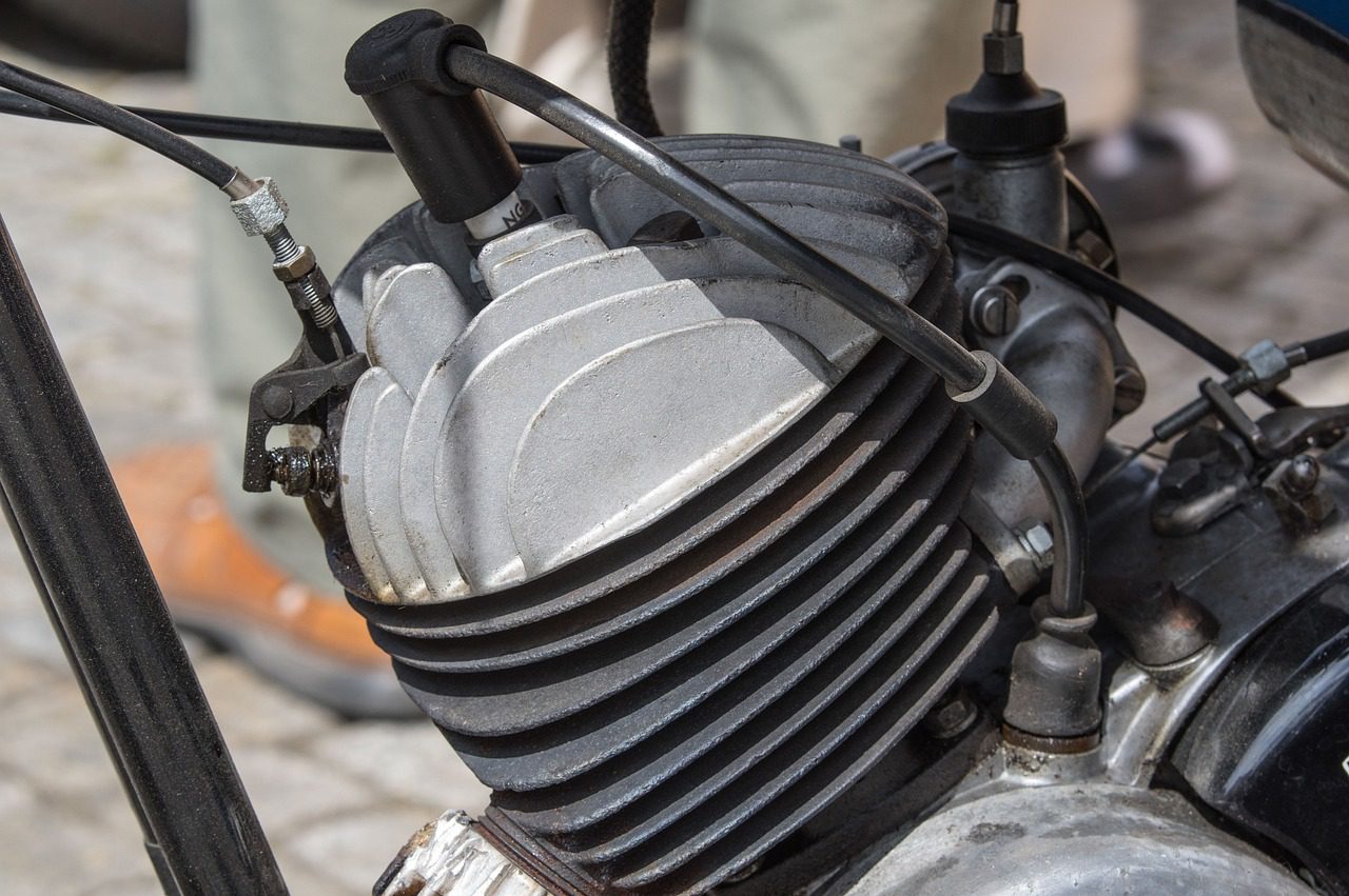 A worn spark plug being inspected, one of the most common causes of a P0316 misfire code