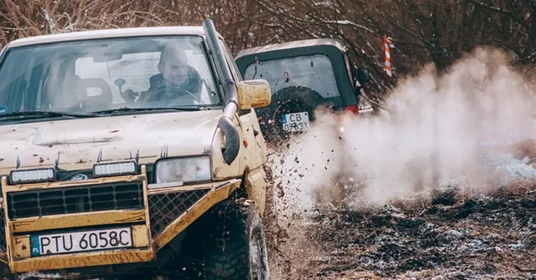 A truck off-roading through mud, illustrating 4-wheel drive engagement on a Chevy Silverado