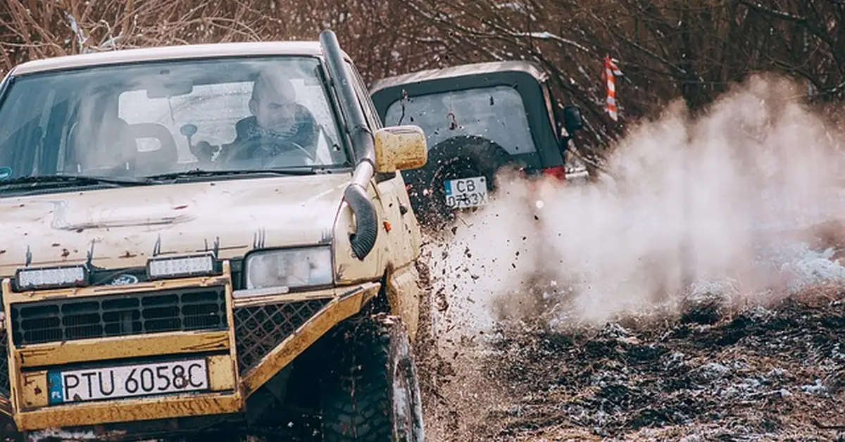 A truck off-roading through mud, illustrating 4-wheel drive engagement on a Chevy Silverado