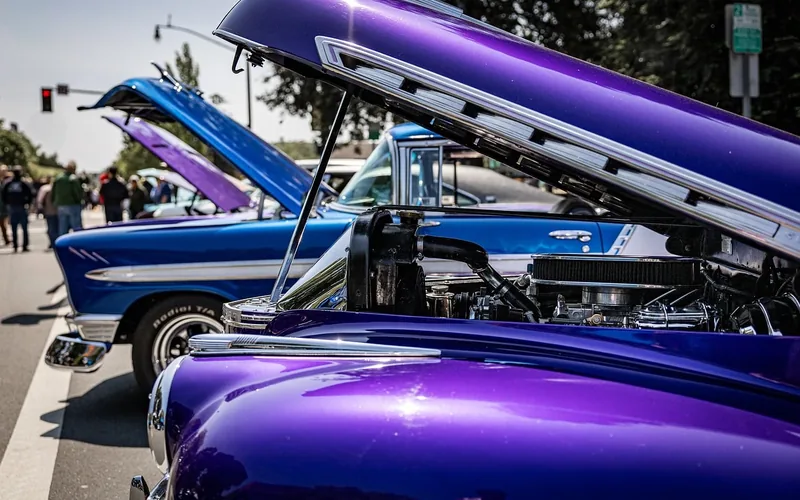 Classic cars with raised hoods at a street car show Classic cars with raised hoods at a street car show