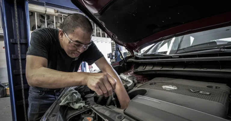 Mechanic performing engine repair at an auto shop