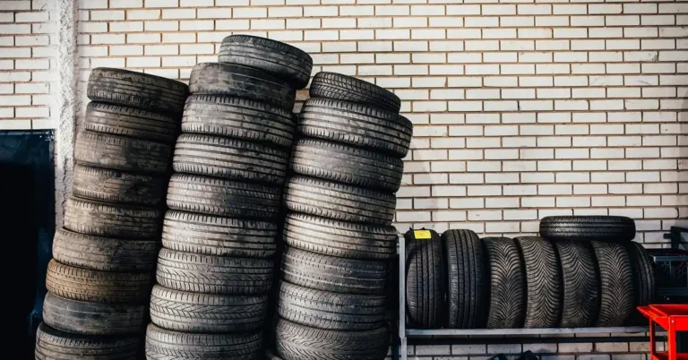 An auto repair shop garage with tires and equipment