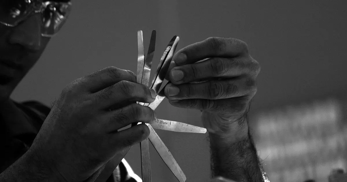 A mechanic using tools during a vehicle maintenance inspection