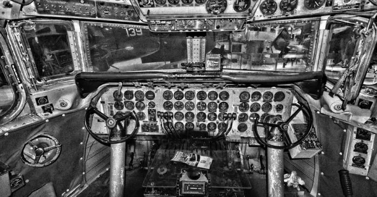 Airplane cockpit control panel with rows of switches and gauges a pilot must monitor