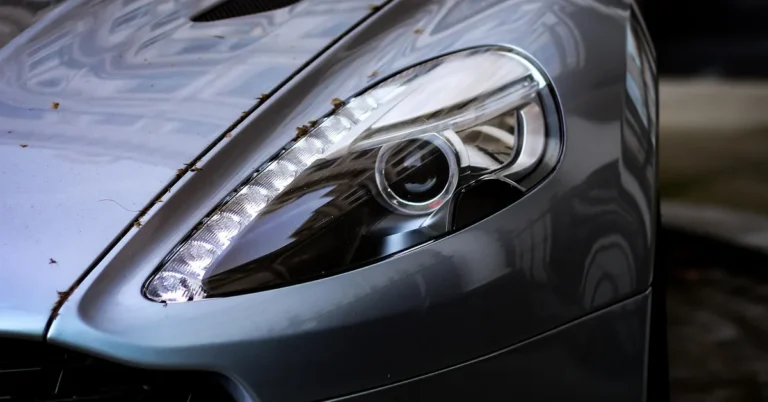 Close-up of a grey sports car headlight and bonnet vent
