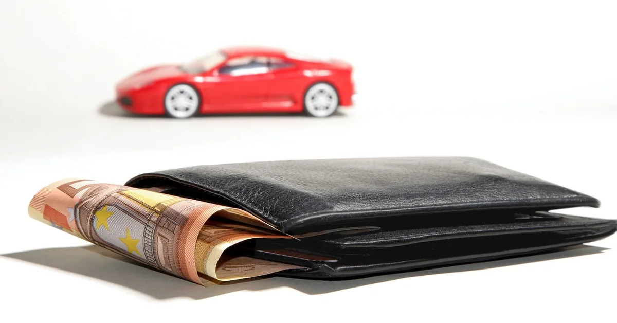 Car buyer reviewing auto loan financing paperwork and interest rate terms