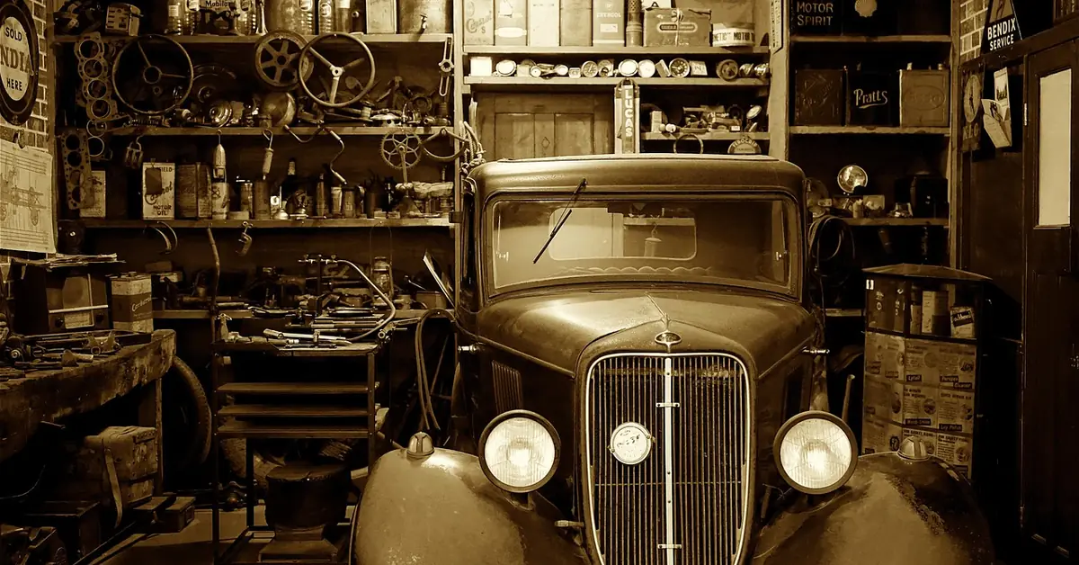 Car enthusiast working on a classic car in a home garage workshop