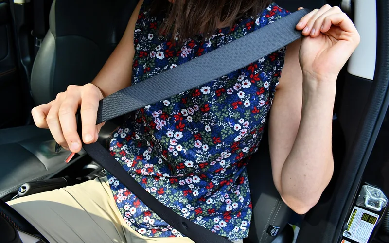close-up of a car seatbelt buckle, the first thing to release when a car is sinking
